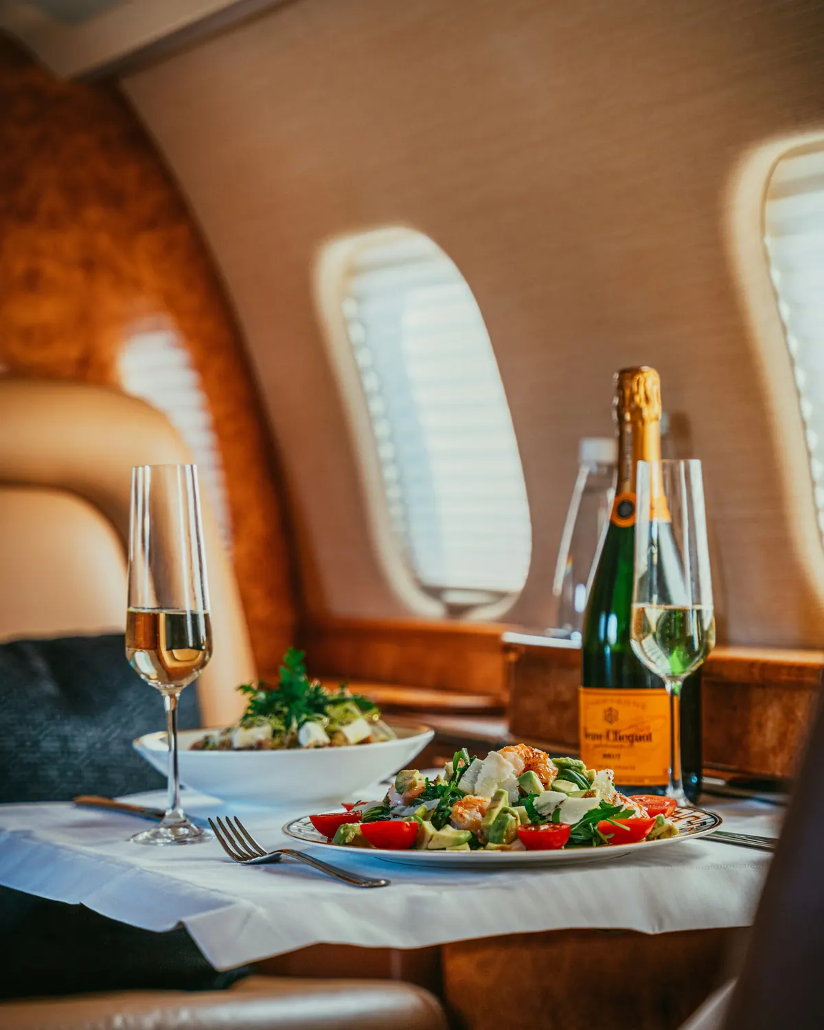 Champagne and a light meal beside a cabin window